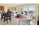 Bright living room featuring dining area, sliding glass doors to balcony, and neutral decor at 880 Mandalay Ave # N710, Clearwater Beach, FL 33767
