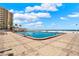 Large outdoor pool with ocean views and ample lounge seating at 880 Mandalay Ave # N710, Clearwater Beach, FL 33767