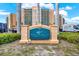 Regatta Beach Club signage, oceanfront residences, with beautiful landscaping and blue sky backdrop at 880 Mandalay Ave # N710, Clearwater Beach, FL 33767