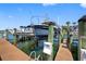 View of the boat dock featuring a lift for a boat, wooden planks, and a serene waterfront setting at 0 Beach Se Dr # 162Ss, St Petersburg, FL 33705