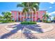 Exterior view of building with lush landscaping, palm trees, and a circular driveway entrance at 0 Beach Se Dr # 162Ss, St Petersburg, FL 33705