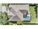 Aerial view of a single Gathering home with a backyard pool, landscaping, and brick patio at 10510 Castleford Way, Tampa, FL 33626