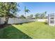 Expansive backyard with lush green grass and a pristine white fence at 10510 Castleford Way, Tampa, FL 33626