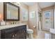Bathroom features a dark vanity, white countertops, and a glass door shower at 10510 Castleford Way, Tampa, FL 33626