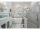 Bright bathroom featuring a soaking tub, glass shower, and white vanity with a glass countertop at 10510 Castleford Way, Tampa, FL 33626