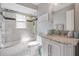 Neutral bathroom featuring marble countertops and a shower/tub combo with glass door at 10510 Castleford Way, Tampa, FL 33626