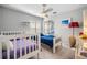bedroom with two twin beds, ceiling fan, and natural light from the windows at 10510 Castleford Way, Tampa, FL 33626