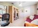Cozy bedroom with a futon, desk, and a storage system at 10510 Castleford Way, Tampa, FL 33626