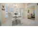 Cozy dining area with a glass table, white chairs, and natural light at 10510 Castleford Way, Tampa, FL 33626