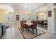 Elegant dining area featuring modern chandelier, large mirror, and natural light at 10510 Castleford Way, Tampa, FL 33626