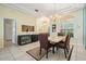 Elegant dining room boasts a modern chandelier, stylish furnishings, and natural light at 10510 Castleford Way, Tampa, FL 33626