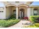 Inviting front entrance with brick walkway, manicured landscaping, and a stylish front door with sidelights at 10510 Castleford Way, Tampa, FL 33626