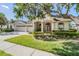 Charming one-story home with a well-manicured lawn, mature landscaping, and a spacious three-car garage at 10510 Castleford Way, Tampa, FL 33626