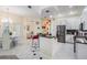 Open kitchen with black countertops, stainless steel appliances, island with pendant lights, and open view to the dining room at 10510 Castleford Way, Tampa, FL 33626