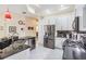 Modern kitchen featuring white cabinets, black countertops, stainless steel appliances, and an island with bar seating at 10510 Castleford Way, Tampa, FL 33626