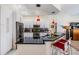 Modern kitchen featuring white cabinets, black countertops, stainless steel appliances, and an island with bar seating at 10510 Castleford Way, Tampa, FL 33626