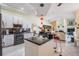 Open kitchen with black countertops, stainless steel appliances, island with pendant lights, and open view to the living room at 10510 Castleford Way, Tampa, FL 33626