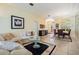 Bright living room featuring a stylish sofa, modern decor, and seamless access to the dining area at 10510 Castleford Way, Tampa, FL 33626