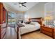 Serene bedroom with sliding glass doors to pool area and stylish wood furnishings at 10510 Castleford Way, Tampa, FL 33626