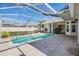 Backyard pool, screened-in lanai with brick patio and landscaping at 10510 Castleford Way, Tampa, FL 33626