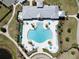 Aerial view of the community pool featuring lounge chairs, umbrellas and lush landscaping around the pool at 11208 Leland Groves Dr, Riverview, FL 33579