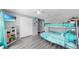 This bedroom offers fun decor, grey floors, a bunk bed and a ceiling fan at 11208 Leland Groves Dr, Riverview, FL 33579