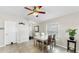 Well-lit dining room with a ceiling fan, table, four chairs, and a window with blinds at 11208 Leland Groves Dr, Riverview, FL 33579