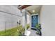 Inviting front entrance featuring a blue door with decorative wreath and potted plants at 11208 Leland Groves Dr, Riverview, FL 33579