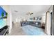 Open concept living room featuring tile floors and a modern sectional sofa with accent pillows at 11208 Leland Groves Dr, Riverview, FL 33579