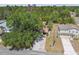 Aerial view of the property showing the house, yard, and surrounding trees at 11383 Pickford St, Spring Hill, FL 34609