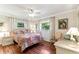 Bedroom with hardwood floors, ceiling fan, and two windows for natural light at 11383 Pickford St, Spring Hill, FL 34609