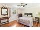 Simple bedroom with hardwood floors, one window, and ceiling fan at 11383 Pickford St, Spring Hill, FL 34609