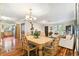 Formal dining room with chandelier lighting and seating for six at 11383 Pickford St, Spring Hill, FL 34609
