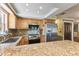 Kitchen with wood cabinets, stainless steel appliances, and granite countertops at 11383 Pickford St, Spring Hill, FL 34609