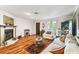 Bright living room with hardwood floors, fireplace, and plenty of natural light at 11383 Pickford St, Spring Hill, FL 34609
