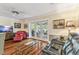 Cozy living room with hardwood floors, ceiling fan, and French doors to the patio at 11383 Pickford St, Spring Hill, FL 34609