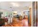 Open living space with hardwood floors, a kitchen island and access to the backyard at 11383 Pickford St, Spring Hill, FL 34609