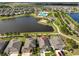Aerial view of the home, community amenities, and a large lake at 11407 Leland Groves Dr, Riverview, FL 33579