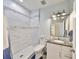 A modern bathroom with wood floors, granite countertop vanity and a separate shower at 11407 Leland Groves Dr, Riverview, FL 33579