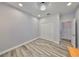 A bedroom with natural light, wood floors, and a closet for storage with a stylish light fixture at 11407 Leland Groves Dr, Riverview, FL 33579