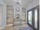 Stylish entryway features modern decor, wood-look floors, decorative wood paneling, and an ornate front door at 11407 Leland Groves Dr, Riverview, FL 33579