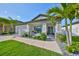 Inviting home with palm trees, stone accents, and a welcoming front porch and walkway at 11407 Leland Groves Dr, Riverview, FL 33579