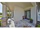 Covered front porch features stone accents, a stylish door, and decorative plants for a welcoming entrance at 11407 Leland Groves Dr, Riverview, FL 33579