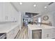 Bright, modern kitchen featuring white cabinetry, quartz countertops, and stainless steel appliances at 11407 Leland Groves Dr, Riverview, FL 33579