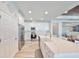 Well-lit kitchen features white cabinetry, stainless steel appliances, and a spacious island with bar seating at 11407 Leland Groves Dr, Riverview, FL 33579