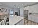 Bright kitchen features quartz countertops, stainless steel appliances, an island with seating, and a large refrigerator at 11407 Leland Groves Dr, Riverview, FL 33579