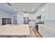 Spacious kitchen with white cabinets, quartz countertops, stainless steel appliances, and a large island at 11407 Leland Groves Dr, Riverview, FL 33579