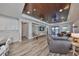 Spacious living room with wood-look tile flooring and a coffered ceiling with wood paneling at 11407 Leland Groves Dr, Riverview, FL 33579