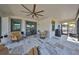 Spacious screened lanai featuring a ceiling fan, outdoor seating, and tile flooring at 11407 Leland Groves Dr, Riverview, FL 33579