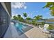 Beautiful backyard pool with water features, lush landscaping, and lake views at 11407 Leland Groves Dr, Riverview, FL 33579